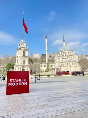 a sign in front of a building with a clock tower at Historical comfy flat in Beyoğlu tophane, galata in Istanbul