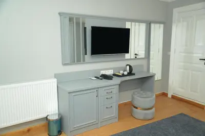a room with a desk with a tv on a wall at CK SULTANAHMET HOTEL in Istanbul