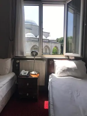 a bedroom with two beds and a window with a view at No20 Hotel Sultanahmet in Istanbul