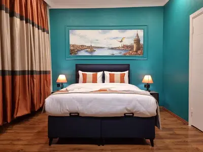 a bedroom with a bed with a blue wall at TAKSİM MY HOUSE BUTİK OTEL in Istanbul
