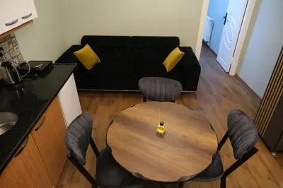 a living room with a table with chairs and a couch at TAKSİM MY HOUSE BUTİK OTEL in Istanbul