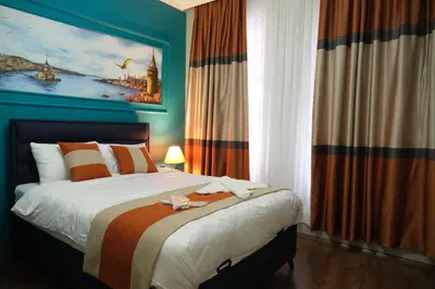a bedroom with a bed with a painting on the wall at TAKSİM MY HOUSE BUTİK OTEL in Istanbul