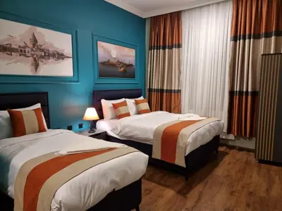 a hotel room with two beds and blue walls at TAKSİM MY HOUSE BUTİK OTEL in Istanbul