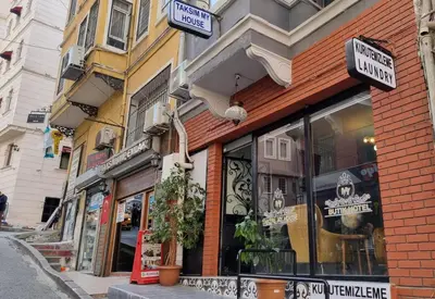 a store with signs on the side of a street at TAKSİM MY HOUSE BUTİK OTEL in Istanbul