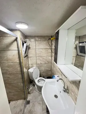 a bathroom with a toilet and a sink and a mirror at Taksim Milenyum Suites in Istanbul