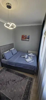 a bedroom with a bed with blue sheets and blue pillows at Taksim Milenyum Suites in Istanbul