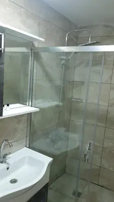a shower with a glass door next to a sink at Taksim Milenyum Suites in Istanbul