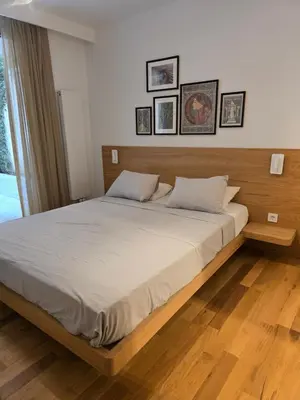 a bedroom with a large bed with a wooden headboard at BFlatz in Istanbul