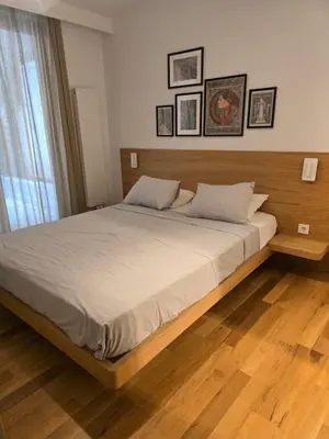 a bedroom with a large bed with a wooden headboard at BFlatz in Istanbul
