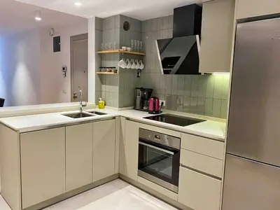 a kitchen with white cabinets and stainless steel appliances at BFlatz in Istanbul