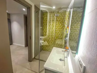 a bathroom with a glass shower and a sink at BFlatz in Istanbul