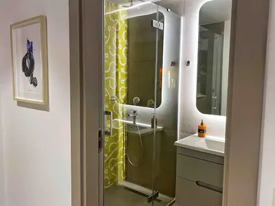 a bathroom with a shower with a yellow shower curtain at BFlatz in Istanbul