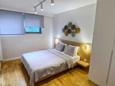 a bedroom with a white bed and a clock on the wall at BFlatz in Istanbul