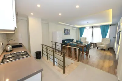 a kitchen and a living room with a table and chairs at Uzay Suite 1 in Istanbul