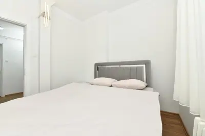 a bedroom with a white bed with two pillows at Dilek Apartments in Istanbul