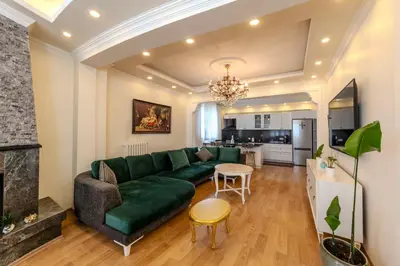 a living room with a green couch and a table at Dilek Apartments in Istanbul
