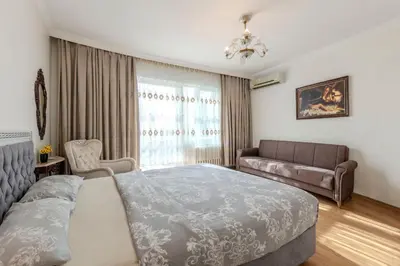 a bedroom with a large bed and a couch at Dilek Apartments in Istanbul