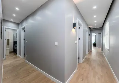 an empty hallway with white walls and wood floors at Dilek Apartments in Istanbul