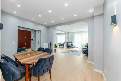 a dining room and living room with a table and chairs at Dilek Apartments in Istanbul
