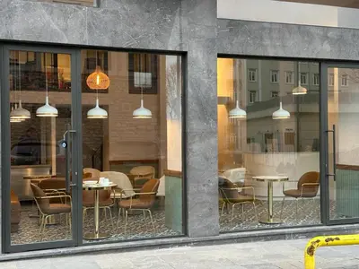 a restaurant with tables and chairs in a window at Iris Han Hotel in Istanbul