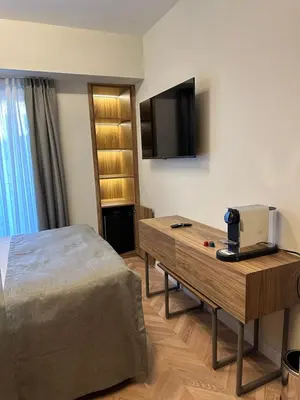 a hotel room with a bed and a table with a television at Iris Han Hotel in Istanbul