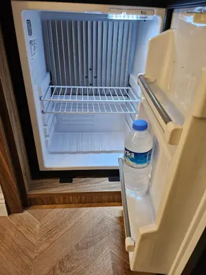 an open refrigerator with a bottle of water in it at Iris Han Hotel in Istanbul