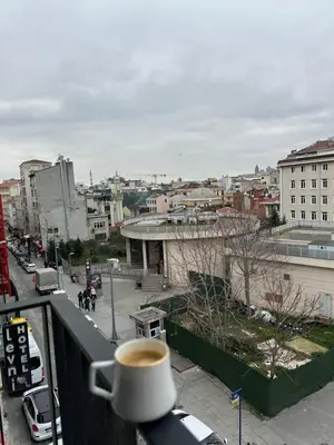 a cup of coffee sitting on top of a balcony at Iris Han Hotel in Istanbul