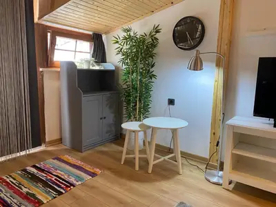 a living room with two tables and a tv at BEYOĞLU in Istanbul