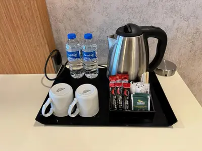 a tray with a coffee maker and water bottles at E5 PARK OTEL in Esenyurt