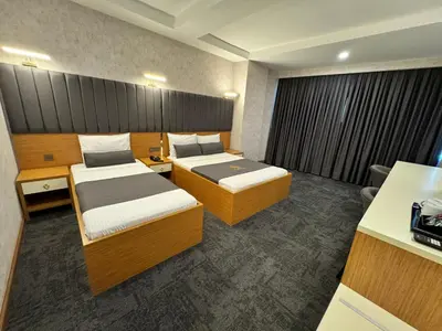 a hotel room with two beds and a desk at E5 PARK OTEL in Esenyurt