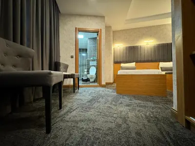 a hotel room with a bed and a bathroom at E5 PARK OTEL in Esenyurt