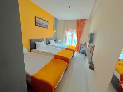 a hotel room with a large bed and a television at N&D&D Hotel in Nilüfer