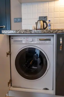 a white washing machine with a pot on top of it at The Row Suites Taksim in Istanbul