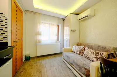 a living room with a couch and a window at Taksim Celebi Suites in Istanbul