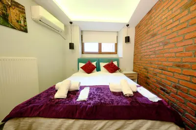 a bedroom with a bed with a brick wall at Taksim Celebi Suites in Istanbul