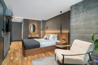 a hotel room with a bed and a chair at Urban Quarters - Gülhane in Istanbul