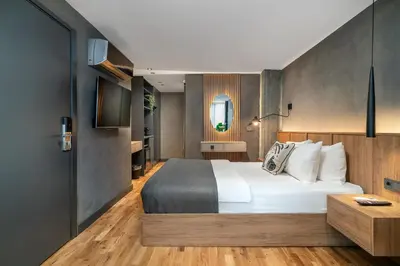 a bedroom with a large white bed and a bathroom at Urban Quarters - Gülhane in Istanbul