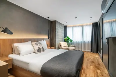 a hotel room with a bed and a chair at Urban Quarters - Gülhane in Istanbul