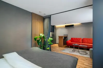 a bedroom with a bed and a red couch at Urban Quarters - Gülhane in Istanbul