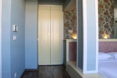 a bedroom with a white door and a bed at Miller Hotel in Istanbul
