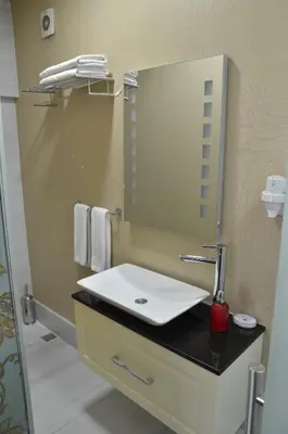 a bathroom with a white sink and a mirror at Miller Hotel in Istanbul