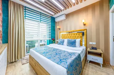a bedroom with a large bed and a window at Sisli Form Hotel in Istanbul