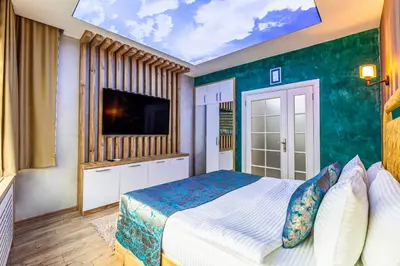 a bedroom with a large bed and a tv at Sisli Form Hotel in Istanbul