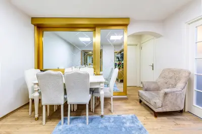 a dining room with a table and chairs and a mirror at Sisli Form Hotel in Istanbul