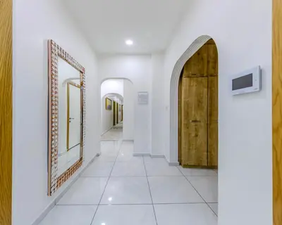 a hallway with a large mirror and a tile floor at Sisli Form Hotel in Istanbul