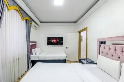 a bedroom with two beds and a window at Sisli Form Hotel in Istanbul