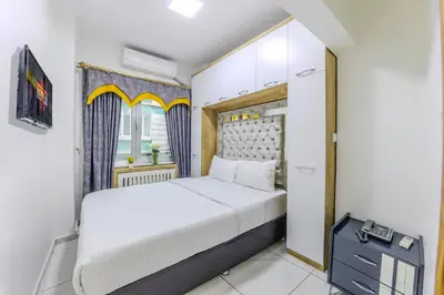 a bedroom with a white bed and a window at Sisli Form Hotel in Istanbul
