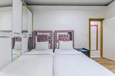 two beds in a room with two mirrors at Sisli Form Hotel in Istanbul