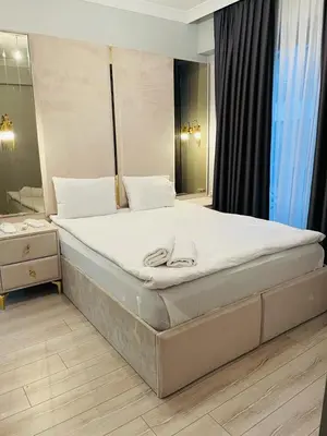 a large bed in a bedroom with a mirror at Cantrmen Suites in Istanbul