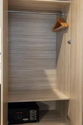 a closet with a wooden cabinet with a radio at The Capri Hotel Osmanbey in Istanbul